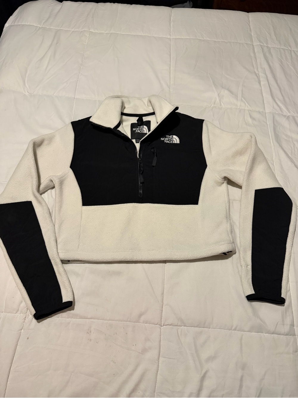 The North Face Black accents on a Cream Cropped Half-Zip Fleece Pullover